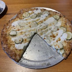Pickle pizza on pretzel crust with ranch drizzle