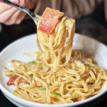 Dell'anima - a person holding a fork full of pasta - Italian Near Me - New York, New York Dell'anima - a person holding a fork full of pasta - Italian Near Me - New York, New York