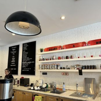 Beans & Malt - a woman standing in a coffee shop - Coffee & Tea Near Me - Flushing, New York