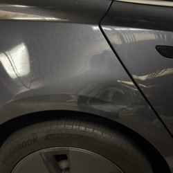 Protek Dent & Scratch Removal - Before photo.Dent with 12 inch crease on quarter panel on this Tesla Model 3.