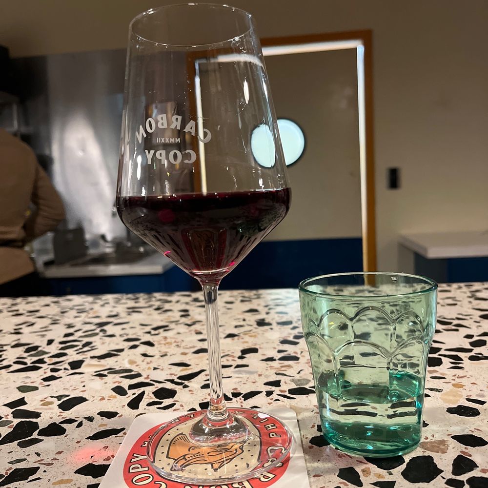 Carbon Copy - a glass of wine and a coaster on a table - Breweries Near Me - Philadelphia, Pennsylvania