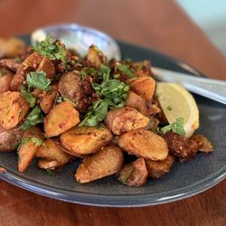 Spread Kitchen - Uber crispy garlic and sumac potatoes are boiled, then frozen, then fried to attain crispness. So, so good!