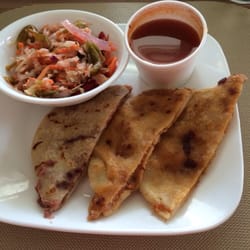 Pupusa Heaven - Bean & pork pupusas taken to go and halved at home, with sides of salsa and pickled veggies.