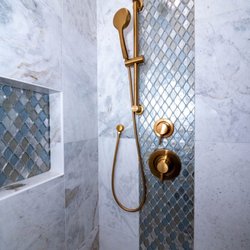 American Home Improvement - Mosaic glass tiled shower with brush gold fixtures