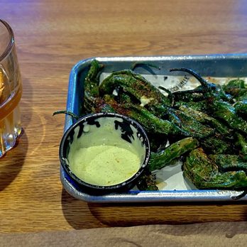 The Tiny Pony - Smoky Mezcal Old Fashioned and roasted shishitos peppers with tahini spice. Lime and jalapeño cilantro ranch sauce. - Bars Near Me - Yucca Valley, California