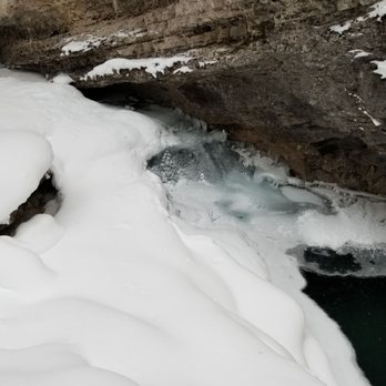Discover Banff Tours - water running underneath the ice - Tours Near Me - Banff, Alberta