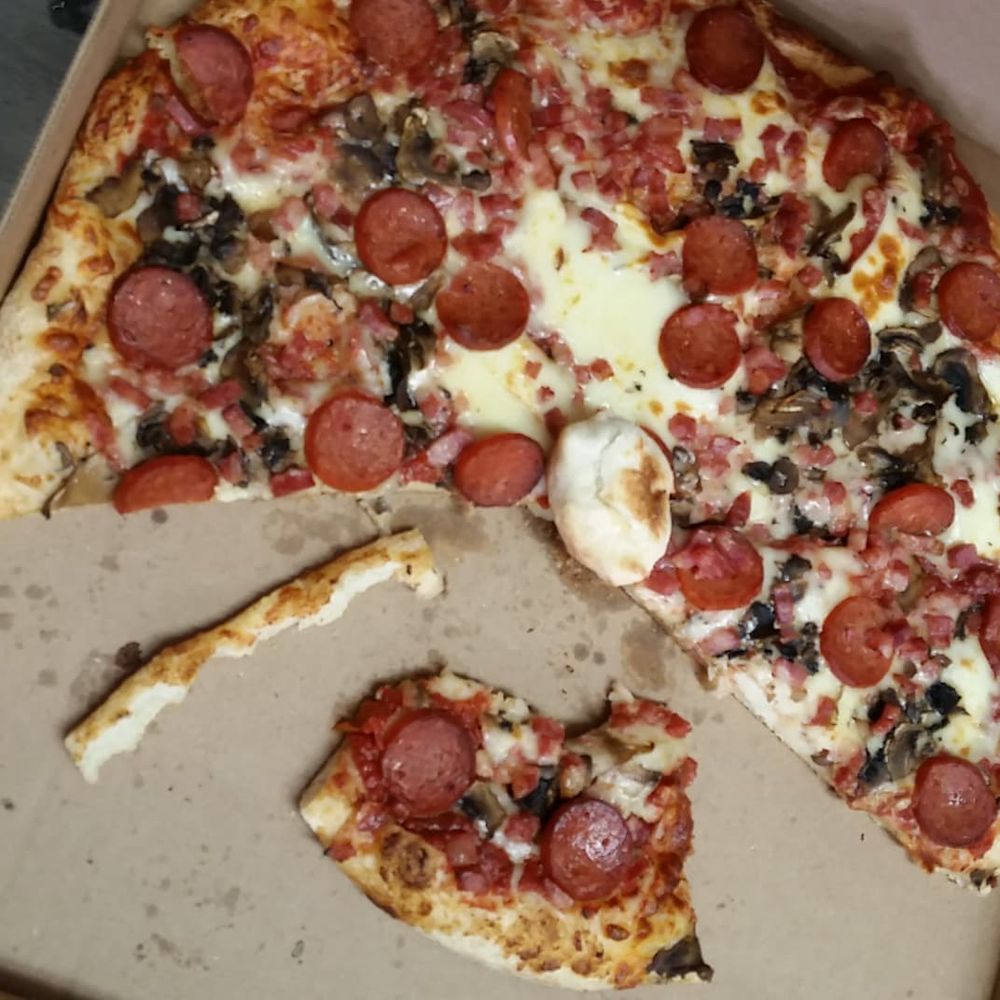 Pizzatown - a pizza in a box with a slice missing - Pizza Near Me - Lower Sackville, Nova Scotia Pizzatown - a pizza in a box with a slice missing - Pizza Near Me - Lower Sackville, Nova Scotia