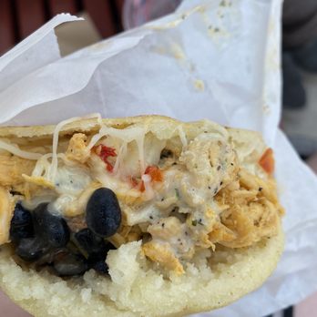 Anytime Arepa - a hand holding a sandwich - Food Trucks Near Me - Milwaukee, Wisconsin