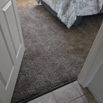 Kading Properties - A bedroom showing tile to carpet in the rooms - Property Management Near Me - Urbandale, Iowa