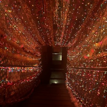 The Rooftop - a walkway covered in christmas lights - Burgers Near Me - Buford, Georgia