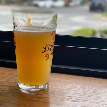 QC Pour House - a glass of beer on a table - American Near Me - Charlotte, North Carolina QC Pour House - a glass of beer on a table - American Near Me - Charlotte, North Carolina