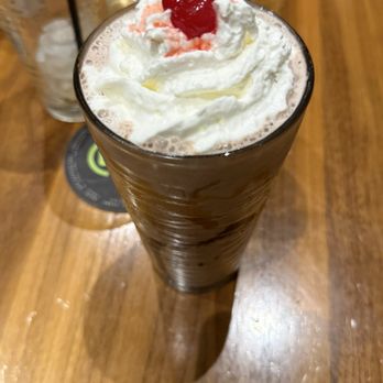 BRU Burger Bar - 50/50 Hand-Dipped Vanilla Milkshake (gf) Hand-Dipped Vanilla Milkshake (gf) w/ fudge & caramel drizzles, whipped cream and a cherry on top - Burgers Near Me - South Bend, Indiana
