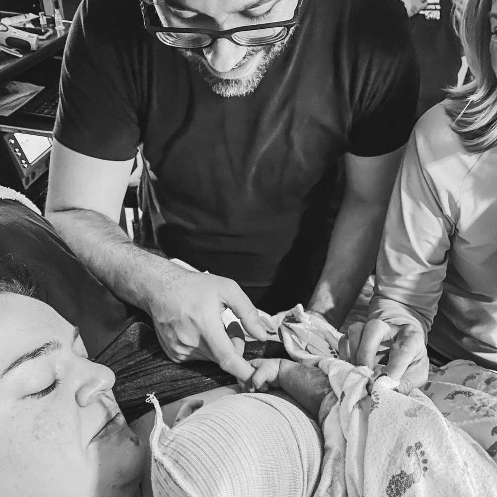 A photo our doula took of our baby's birth. A photo our doula took of our baby's birth.