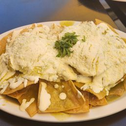Chilaquiles with 2 over easy eggs on top. Chilaquiles with 2 over easy eggs on top.