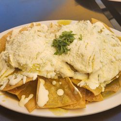 Chilaquiles with 2 over easy eggs on top.