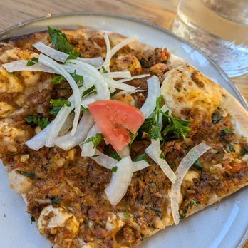Esnaf - A slice of the lahmacun with the tomato and onion side as topping - Turkish Near Me - San Carlos, California Esnaf - A slice of the lahmacun with the tomato and onion side as topping - Turkish Near Me - San Carlos, California