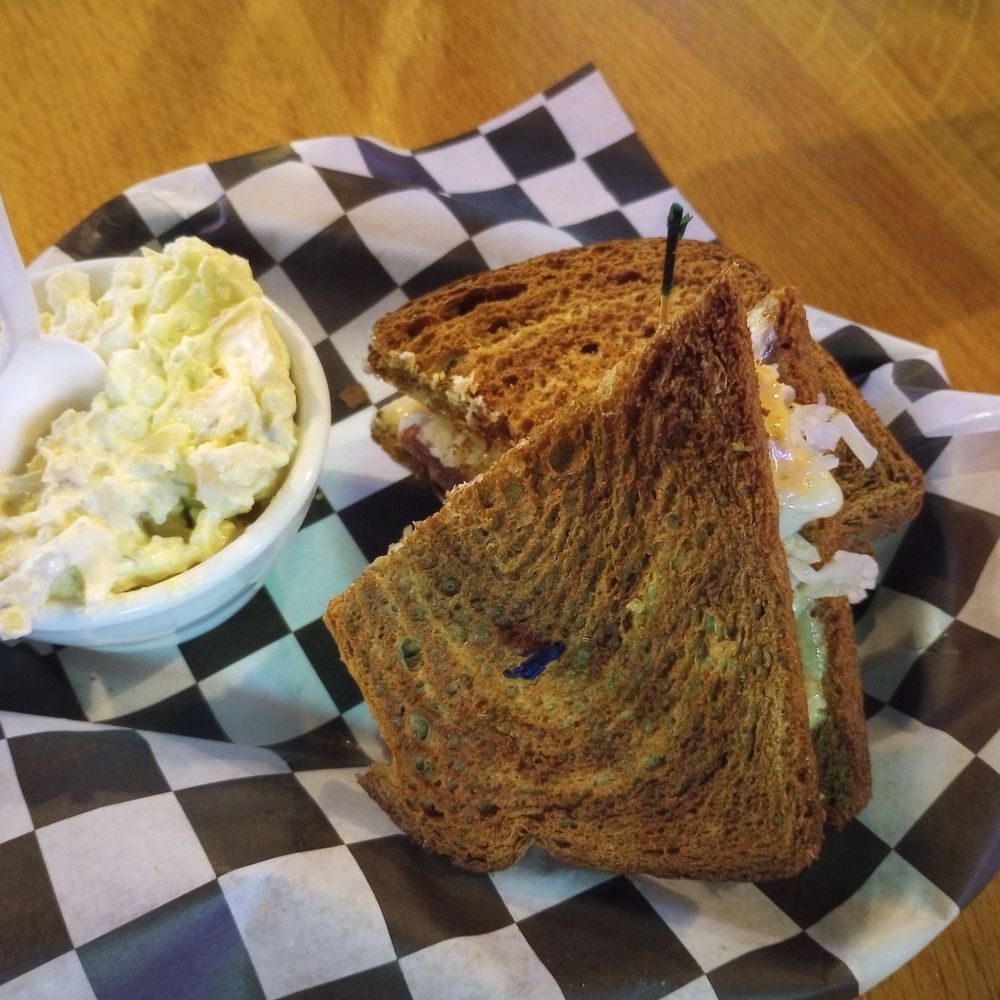 The Oasis Bar - Reuben sandwich with toasted marble bread & amazing creamy potato salad - Pubs Near Me - Castle Rock, Washington The Oasis Bar - Reuben sandwich with toasted marble bread & amazing creamy potato salad - Pubs Near Me - Castle Rock, Washington
