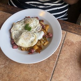 Corned beef hash with over medium eggs.