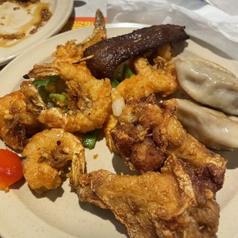 Hong Kong Buffet - Food - A plate with fried shrimp, dumplings, and fried chicken, along with a sausage and some vegetables, served at a Chinese buffet. - Chinese Near Me - Cranston, Rhode Island