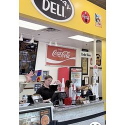 East Bay Deli - Columbia - The rude girl at the cash register and the other girl in the back kitchen .