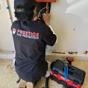 Prestige Fire Protection - Technician repairing a residential fire riser leak - Fire Protection Services Near Me