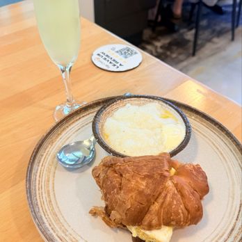 Eggcited Brunch House - Pineapple mimosas and bacon, egg and cheese croissant - Breakfast & Brunch Near Me - McKinney, Texas