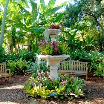 Greenscapes - a fountain and benches in a tropical garden - Landscaping Near Me - Sarasota, Florida Greenscapes - a fountain and benches in a tropical garden - Landscaping Near Me - Sarasota, Florida