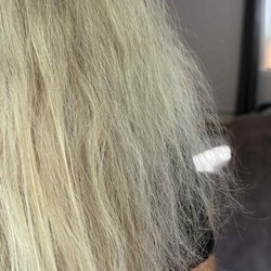 Tulu Salon and Spa - Close-up showing visible dryness and breakage in multiple sections the morning after the service.