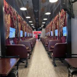 Lizzies Dining Car & Caboose Bar - The restaurant looks like a Dining Car on a train and the screens on the walls have videos of beautiful scenery.