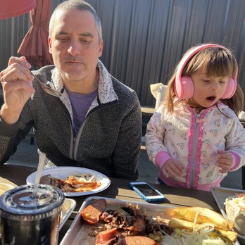Tender Smokehouse - Daddy and daughter enjoying food outdoors - Barbeque Near Me - Celina, Texas Tender Smokehouse - Daddy and daughter enjoying food outdoors - Barbeque Near Me - Celina, Texas