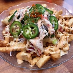 Sashimi fries. Tuna, salmon, and imitation crab with seaweed salad and jalapeño on Old Bay seasoned French Fries.