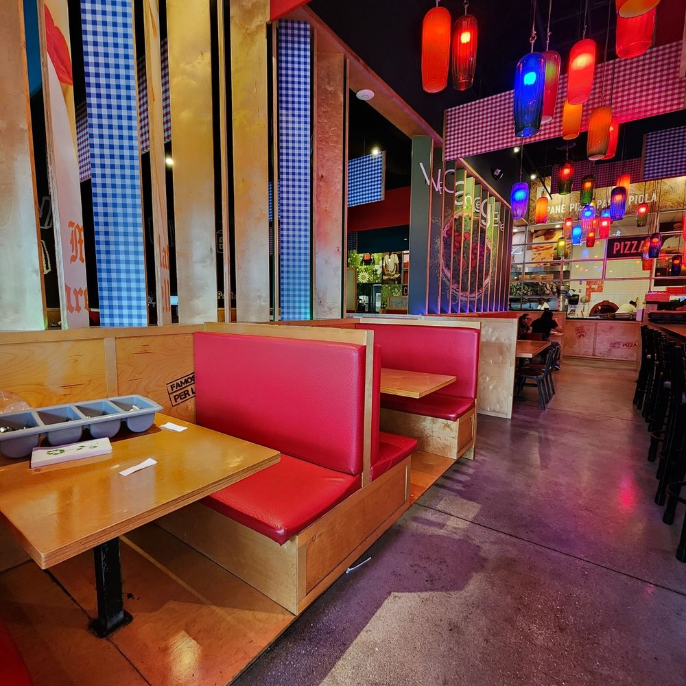Piola - the interior of a restaurant with red booths - Pizza Near Me - Doral, Florida Piola - the interior of a restaurant with red booths - Pizza Near Me - Doral, Florida