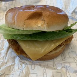 Ghost Pepper Ranch Chicken Sandwich - A chicken sandwich features a breaded chicken patty, a slice of cheese, lettuce, and a bun, served on Wendy's branded paper.