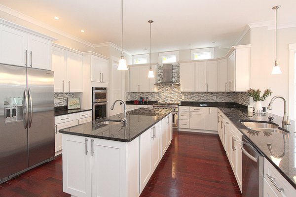 Complete kitchen remodeling - Custom White Shaker-Style Cabinets: Crisp, timeless white cabinetry throughout (including full-height upper cabinets and ample lower storage) for a clean, airy feel that brightens the entire room. Soft-close drawers and doors for everyday luxury and durability.
Large Center Island with Black Granite Countertop: A spacious, multi-functional island topped with rich black granite — providing dramatic contrast, plenty of prep space, seating for casual meals, and a bold focal point.
Matching Black Granite Countertops & Backsplash Accents: Seamless, durable surfaces on all perimeter counters, paired with a stylish mosaic or subway tile backsplash for added texture and easy maintenance.
Premium Hardwood Flooring: Warm, rich dark hardwood floors installed throughout, adding elegance, warmth, and timeless appeal while standing up to South Florida's humidity and daily traffic.
High-End Appliances & Fixtures: Integrated stainless steel appliances (oven, cooktop, dishwasher), modern undermount sink, elegant curved faucet, and energy-efficient LED under-cabinet lighting.
Updated Lighting: Sleek pendant lights over the island for task and ambient illumination, plus recessed ceiling lights for even, inviting brightness.
Additional Enhancements: Full plumbing/electrical updates, new ventilation (range hood), custom storage solutions (pull-outs, organizers), and meticulous attention to detail like crown molding, hardware, and paint/finishes. Complete kitchen remodeling - Custom White Shaker-Style Cabinets: Crisp, timeless white cabinetry throughout (including full-height upper cabinets and ample lower storage) for a clean, airy feel that brightens the entire room. Soft-close drawers and doors for everyday luxury and durability.
Large Center Island with Black Granite Countertop: A spacious, multi-functional island topped with rich black granite — providing dramatic contrast, plenty of prep space, seating for casual meals, and a bold focal point.
Matching Black Granite Countertops & Backsplash Accents: Seamless, durable surfaces on all perimeter counters, paired with a stylish mosaic or subway tile backsplash for added texture and easy maintenance.
Premium Hardwood Flooring: Warm, rich dark hardwood floors installed throughout, adding elegance, warmth, and timeless appeal while standing up to South Florida's humidity and daily traffic.
High-End Appliances & Fixtures: Integrated stainless steel appliances (oven, cooktop, dishwasher), modern undermount sink, elegant curved faucet, and energy-efficient LED under-cabinet lighting.
Updated Lighting: Sleek pendant lights over the island for task and ambient illumination, plus recessed ceiling lights for even, inviting brightness.
Additional Enhancements: Full plumbing/electrical updates, new ventilation (range hood), custom storage solutions (pull-outs, organizers), and meticulous attention to detail like crown molding, hardware, and paint/finishes.