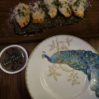 The Rose Garden AZ - Beef & manchego empanadas on peacock plates - Cocktail Bars Near Me - Phoenix, Arizona