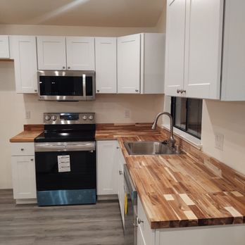 Golden State Handyman - a kitchen with white cabinets and wood countertops - Handyman Near Me Golden State Handyman - a kitchen with white cabinets and wood countertops - Handyman Near Me