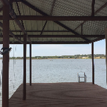 A & D Construction - a dock with a boat in the water - General Contractors Near Me