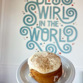 Kinnamons - a hand holding a frosted cupcake - Desserts Near Me - Beaverton, Oregon Kinnamons - a hand holding a frosted cupcake - Desserts Near Me - Beaverton, Oregon