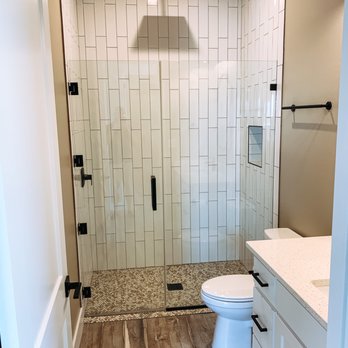 Manning Construction & Roofing - a bathroom with a shower, toilet, and sink - Roofing Near Me Manning Construction & Roofing - a bathroom with a shower, toilet, and sink - Roofing Near Me