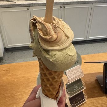 Bacio di Latte - Crema Torino (Top) and Pistacchio (bottom) in Waffle Cone - Gelato Near Me - Calabasas, California Bacio di Latte - Crema Torino (Top) and Pistacchio (bottom) in Waffle Cone - Gelato Near Me - Calabasas, California
