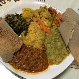 Veggie platter -- three kinds of lentils, greens, cauliflower and light-as-air injera. So good!