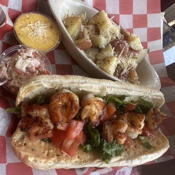 Shrimp & Co. Restaurant - Shimp Po' Boy Deluxe with seasoned potatoes and house made crab sauce on the side - Seafood Near Me - Tampa, Florida Shrimp & Co. Restaurant - Shimp Po' Boy Deluxe with seasoned potatoes and house made crab sauce on the side - Seafood Near Me - Tampa, Florida