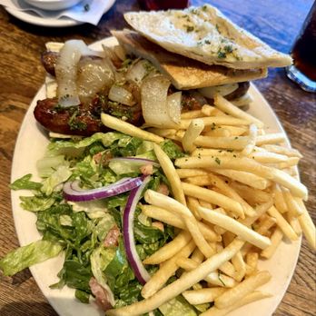 Lala's Argentine Grill - Chorizo Sandwich with grilled onions. Served with fried & salad. A generous portion for sure. - Argentine Near Me - Studio City, California