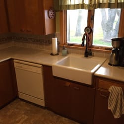 Tramco Kitchen and Bath - New laminate countertop, tile backsplash and a farmhouse sink.