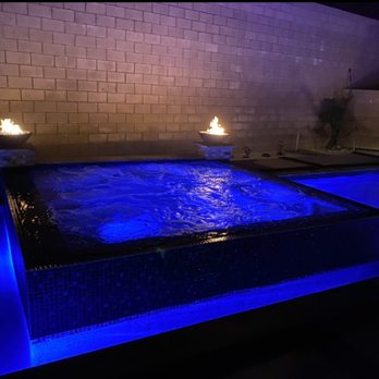 VC Hardscapes - a hot tub lit with blue lights - General Contractors Near Me