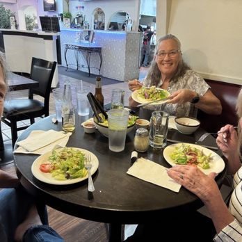 Zorba's Pizza - This is three girls partaking in a Greek salad - Italian Near Me - Millbrae, California Zorba's Pizza - This is three girls partaking in a Greek salad - Italian Near Me - Millbrae, California