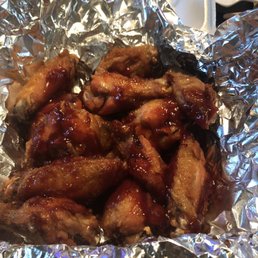 a plate of chicken wings covered in bbq sauce a plate of chicken wings covered in bbq sauce