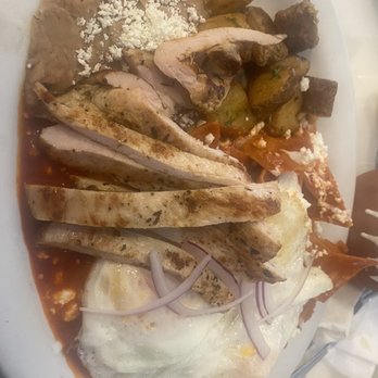 El Sazon de los Abuelos - Chilaquiles plate with two over easy eggs and grilled chicken potatoes, beans, and cheese - Mexican Near Me - Tecate, BCN