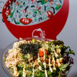 a hand holding a bowl of food