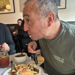 Xavier fully investing himself in the breakfast club croissant.